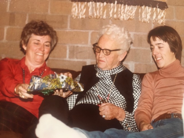 Vintage picture of Mom, Meme, and my brother as they unwrap a package.